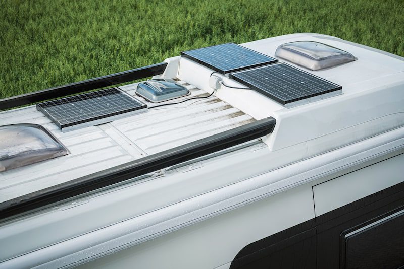 Close View Of Parked Camper Van With Three Solar Panels